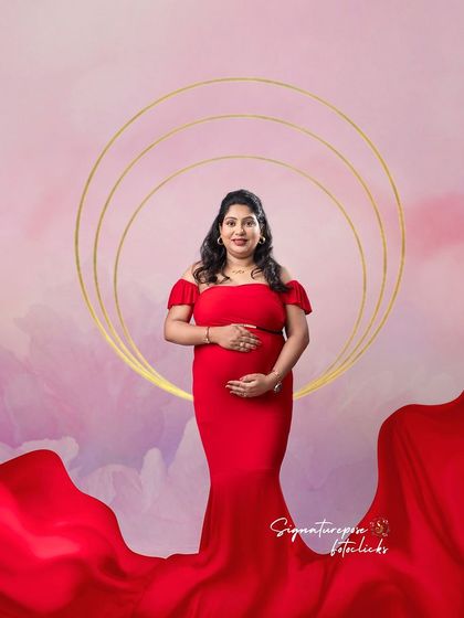 A similar artistic concept, with golden rings and a flowing red gown against a pastel sky backdrop.