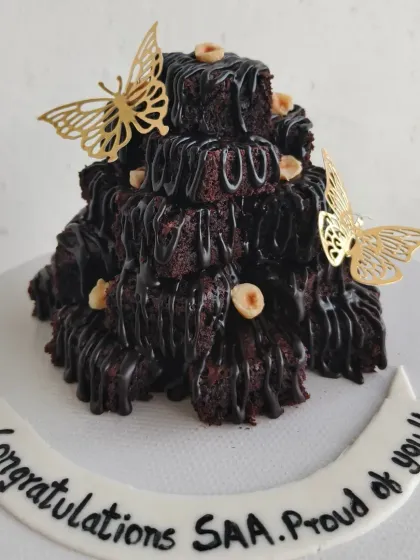This is my signature Brownie Tower, a super fun and delicious alternative to a traditional celebration cake. It's made of stacks of my fudgy chocolate brownies, drizzled with more chocolate, and perfect for sharing.