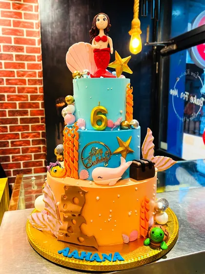 An enchanting three-tier mermaid cake that dives deep into imagination. With a handcrafted mermaid topper, edible seashells, coral, and a friendly whale, this underwater fantasy cake made a huge splash at a 6th birthday party.